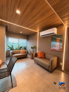 a living room with a couch and a air conditioner at Hotel Vivenda dos Corais in Porto De Galinhas
