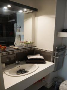 a bathroom with a sink and a large mirror at T1bis duplex Hyper centre historique de BX in Bordeaux