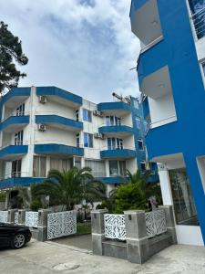 a blue building with a car parked in front of it at National Lux in Ureki