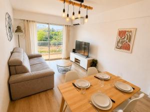 a living room with a table and a couch at Résidence Riviera Parc in Cagnes-sur-Mer