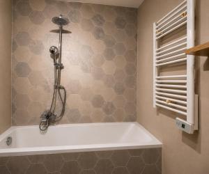 a white bath tub in a bathroom next to a window at Résidence Riviera Parc in Cagnes-sur-Mer