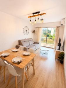 a living room with a table and a couch at Résidence Riviera Parc in Cagnes-sur-Mer