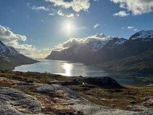a view of a lake in the middle of a mountain at Cozy apartment in Tromsø +13 photos
