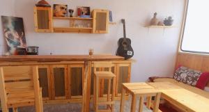 a kitchen with a bar and a guitar on the wall at Rooftop Hostel Dakhla in Dakhla +39 photos