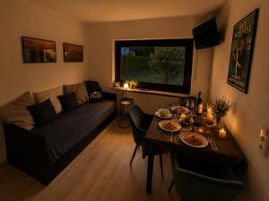 a living room with a table and a couch at Gate 18 in Haiger