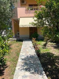 a walkway leading to the front of a house at Besart Room in Orikum