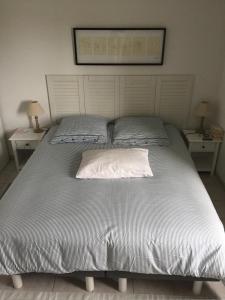a bed with two pillows on it in a bedroom at La Paloma in Aigues-Mortes +21 photos