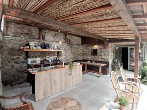 an outdoor kitchen with a counter and a table at Esposende Garden in Esposende