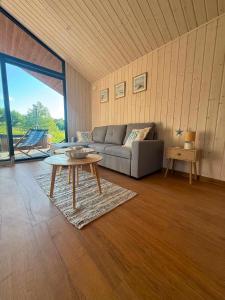 a living room with a couch and a table at Łeba Luxury House in Łeba