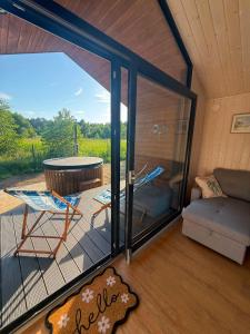 a room with a screened in porch with a couch and a table at Łeba Luxury House in Łeba