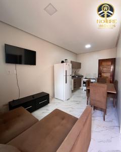 a living room with a couch and a refrigerator at Casa completa com 2 quartos no Bairro Alvorada in Santarém +3 photos