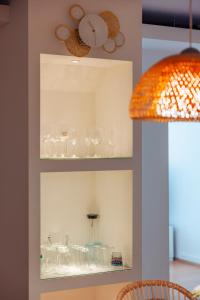 a shelf with glasses on it with a lamp at Haus Spiegel - Cramergasse, Lindau Insel in Lindau +30 photos