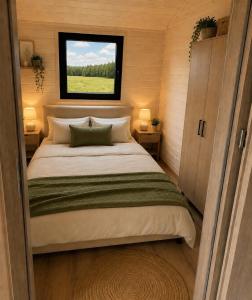 a bed in a small room with a window at Łeba Luxury House in Łeba