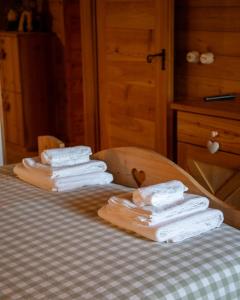 a pile of towels sitting on top of a table at Baita dei Fovi in Baselga di Pinè +32 photos