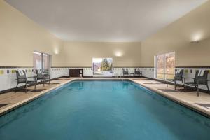 a large swimming pool with chairs and a swimming pool at Fairfield Inn & Suites by Marriott Marietta in Marietta