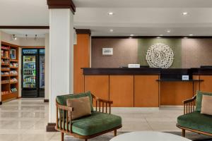 a waiting room with two chairs and a bar at Fairfield Inn & Suites by Marriott Marietta in Marietta +32 photos