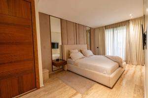 a bedroom with a white bed and a window at Comfort and luxury with pool in Tamaris +11 photos