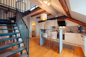 a kitchen and staircase in a loft with white cabinets at Haus Spiegel - Cramergasse, Lindau Insel in Lindau