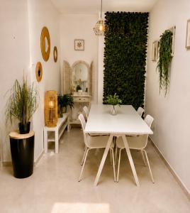 a dining room with a white table and chairs at Kyel location in Ashdod