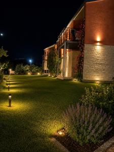a large lawn in front of a building at night at Glikis ear apartments in Gliki +4 photos
