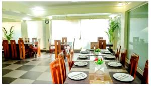 a large dining room with a long table with chairs and a tableablish at The Mint Calangute in Calangute
