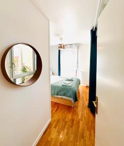 a bedroom with a bed and a mirror at Blue Harmony in Massy +10 photos