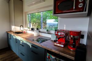 a kitchen with a red mixer on a counter at Horizont Hillside Mályinka in Mályinka