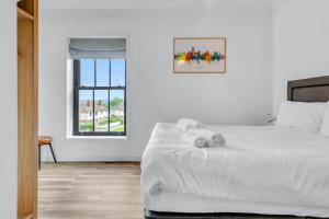 a white bed with a stuffed animal on top of it at Larkey View A Tranquil Space For Two - Pass the Keys in Canterbury
