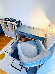a room with a blue chair and a desk at Blue Harmony in Massy