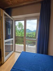 a bedroom with a large glass door with a view at Willa Zwinka in Szczawnica +25 photos