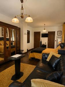 a living room with a couch and a bed at Les Ruisseaux in Cauterets