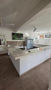 a kitchen with a white counter top in a room at Maji Pearl Hotel & Spa in Nungwi