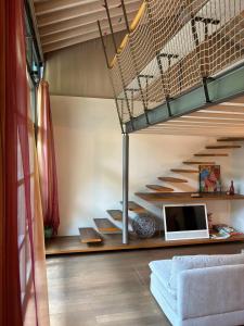 a room with a loft bed with a laptop on a desk at La Casetta del Lago in Lovere