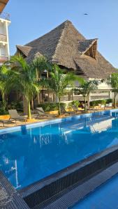 a swimming pool in front of a resort at Maji Pearl Hotel & Spa in Nungwi