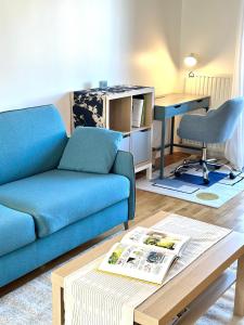 a living room with a couch and a table at Blue Harmony in Massy
