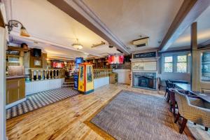 a large room with a yellow vending machine in it at The Greyhound Hotel in Leigh