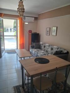 a living room with a couch and a table at Kalyves Beach in Kalives Poligirou