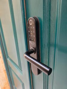 a black door handle on a green door at Lausa Dubrovnik Rooms in Dubrovnik