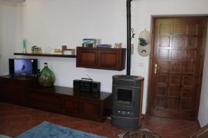a room with a stove and a desk and a door at Villa Gina in Villar Pellice