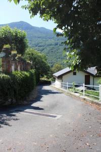 a road leading to a building with mountains in the background at Villa Gina in Villar Pellice