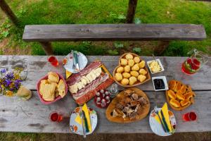 a picnic table with plates of food on it at Eko Kamp Garcevic in Plav +57 photos