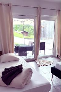 a bedroom with two beds and a large window at Apartment Oberleins II in Arzl im Pitztal