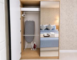 a mirror in a bedroom with a bed at Modern 12th Floor Condo Walk to Phuket Old Town with Pool & Gym in Phuket +13 photos