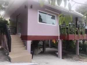 a house with a staircase and a window at Elevated Bungalow House 3-11 in Nathon Bay