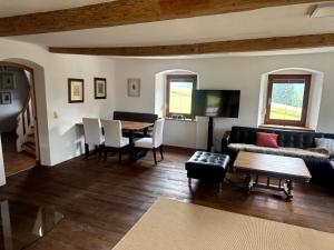 a living room with a couch and a table at Familien Ferienhaus in Bad Elster Vogtland - Natur pur und Wellness in Bad Elster