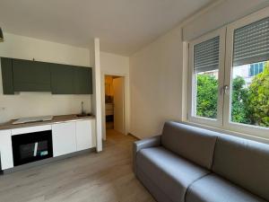 a living room with a couch and a kitchen at Bigò Apartments in Termoli