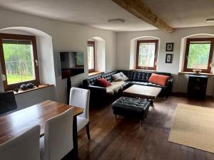 a living room with a couch and a table at Familien Ferienhaus in Bad Elster Vogtland - Natur pur und Wellness in Bad Elster