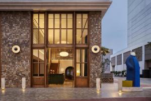 a lobby of a building with a large glass door at Humano, Lima, a Tribute Portfolio Hotel in Lima