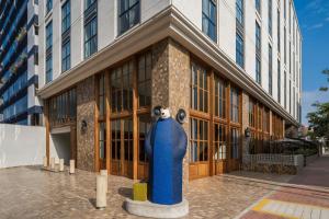 a blue fire hydrant in front of a building at Humano, Lima, a Tribute Portfolio Hotel in Lima