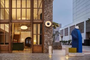 a large blue statue in front of a building at Humano, Lima, a Tribute Portfolio Hotel in Lima +54 photos